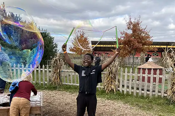 kids playing making giant bubbles