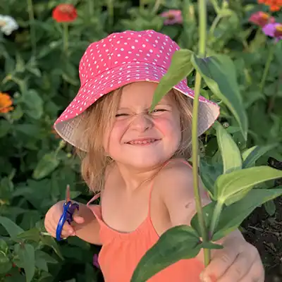 girl in zinnia flower patch