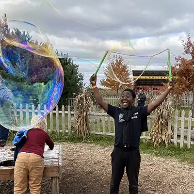 kids playing with giant bubbles