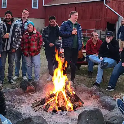 adults around a campfire